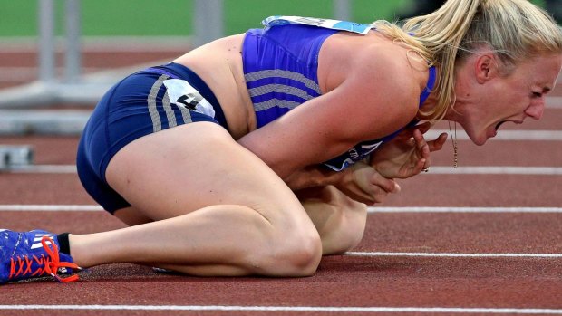 Sally Pearson shouts in pain after hitting a hurdle and tripping in Rome. 