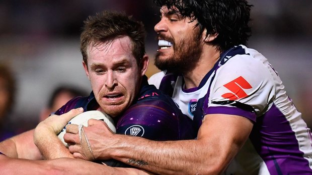 The Cowboys' Michael Morgan is tackled by Storm's Tohu Harris during the round-21 match.