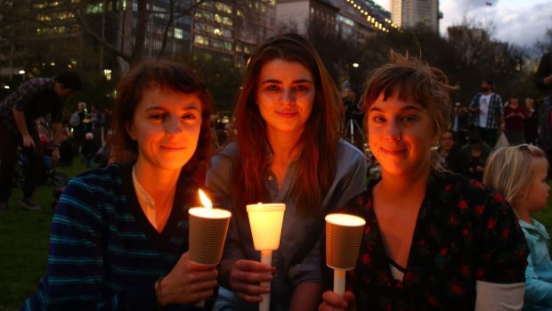 Lighting candles in Sydney in support of refugees: debate is now turning to the cost of refugees' resettlement.