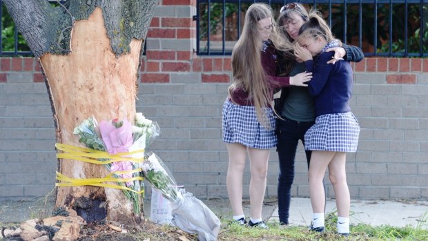Grieving friends pay their tributes at the scene.
