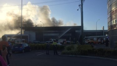 Firefighters battle flames at a Lexus dealership in Townsville.