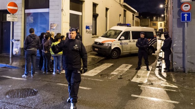 Police search a house in the Molenbeek neighborhood of Brussels on Tuesday.