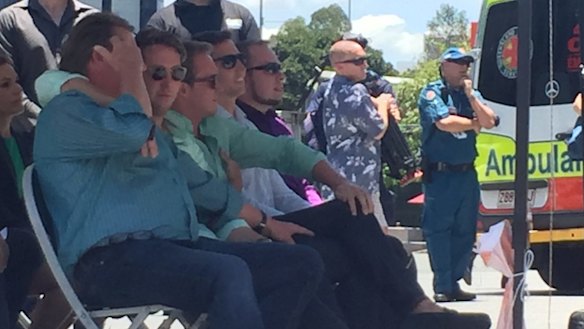 Cole Miller's brother Mitch, seated beside their other brother Billy, puts his arm around dad Steve.