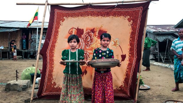 La La, 10, and Noor Bi, 8,  sell fish at the market in the Sin Tet Maw camp for internally displaced persons in Rakhine State, Myanmar.