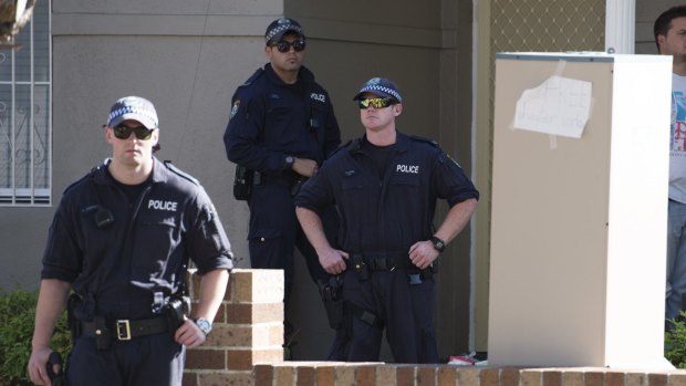 Police raid a property in Punchbowl as they target an alleged extortion scam.
