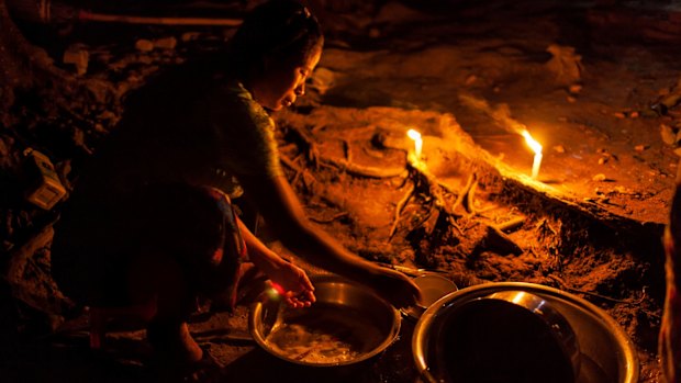 A woman washes dishes at the Phan Khar Kone IDP camp in Bhamo city, Kachin State.