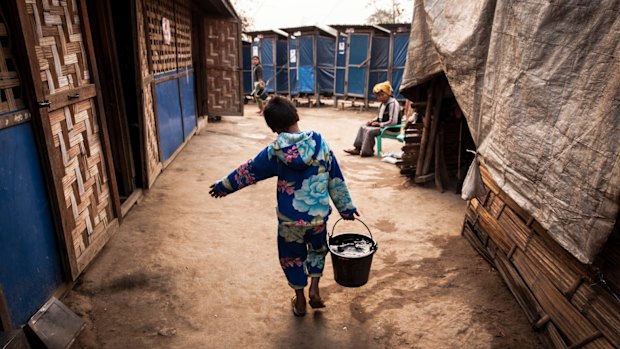 Aung Din, 12, displaced from Mung Ding Pa, collects water every morning for his household at the Phan Khar Kone IDP camp in Bhamo city, Kachin State.