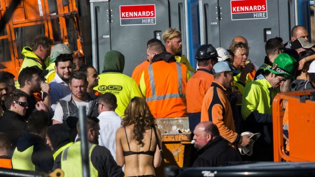 Strippers were seen handing out drinks and mingling with construction workers at the Geocon Wayfarer apartment building site in Belconnen on Friday afternoon.