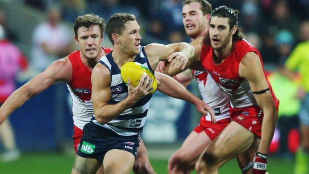 Cats captain Joel Selwood is surrounded by Swans in the round 16 match at Simonds Stadium.