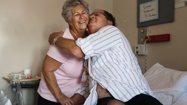 Tommy Raudonikis with his partner Trish Brown in his hospital room.