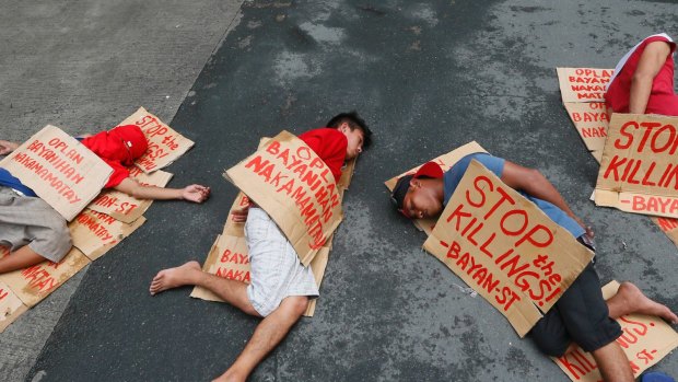 People stage a "die-in" to protest the rising number of extra judicial killings related to Philippine President Rodrigo Duterte's "War on Drugs".