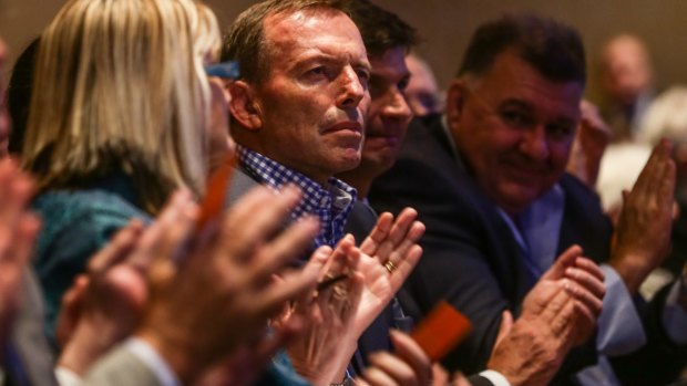 Former prime minister Tony Abbott observed from his front-row seat while several hundred members in the rows behind had his back. 