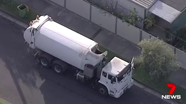 The driver of this garbage truck discovered the body. 