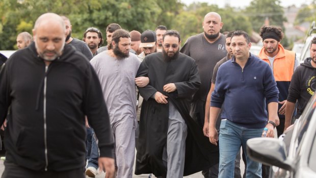 Sheikh Mohamad Abou Eid wears dark glasses as he walks to Preston Mosque before Friday prayers.