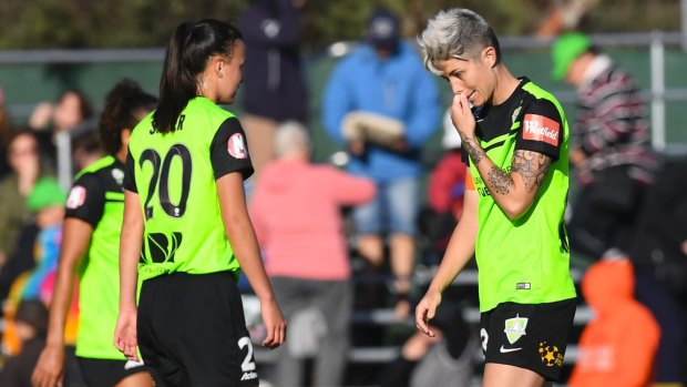 Canberra United's Amy Sayer and Michelle Heyman show their disappointment after the loss.