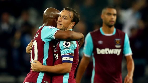 Andre Ayew (left) and Mark Noble embrace after the final whistle.
