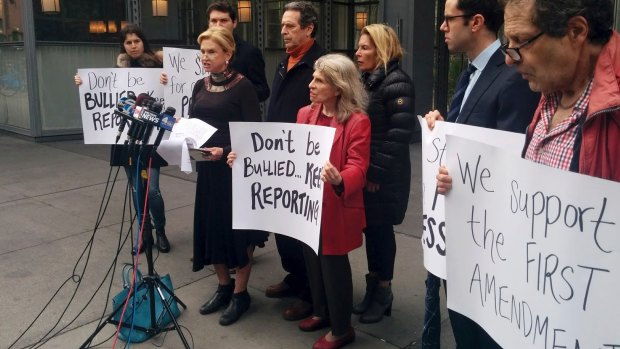 Democratic congresswoman Carolyn Maloney, foreground left, addresses the media in front of the <i>New York Times</i> offices on Saturday, after the newspaper and other media were barred from a Trump administration press briefing.