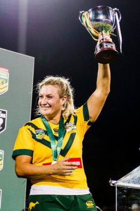 Jillaroos captain Ruan Sims, who won player of the match, lifts the trophy.