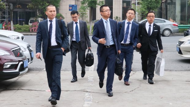 Li Haojun (third from left) lawyer for jailed Crown employee Jason O'Connor arrives at the Baoshan District Court on Monday, flanked by other members of his firm. 