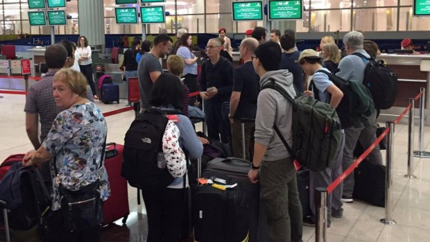 Passengers queue in hope of return to Sydney at Dubai International Airport