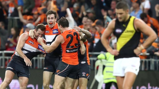 Out of jail: Jeremy Cameron and teammates celebrate the GWS Giants' comeback win last month.