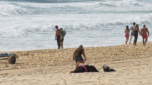 A woman collapses on Maroubra Beach during the search for a 14-year-old boy.