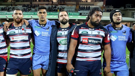 In the firing line: Force and Rebels players provide a show of unity following their final game of the Super Rugby season. One team will go. But is that enough?