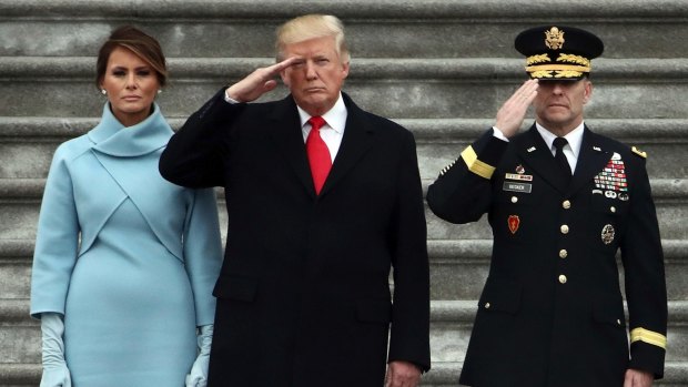 President Donald Trump with first lady Melania Trump and Major General Bradley Becker review troops in Washington.