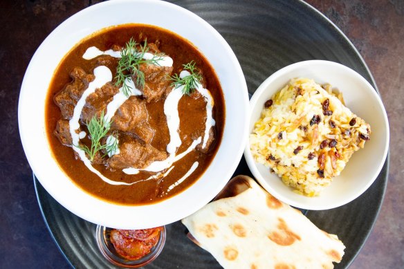 Goat curry with grilled roti bread, almond rice pilaf and lime pickle. 