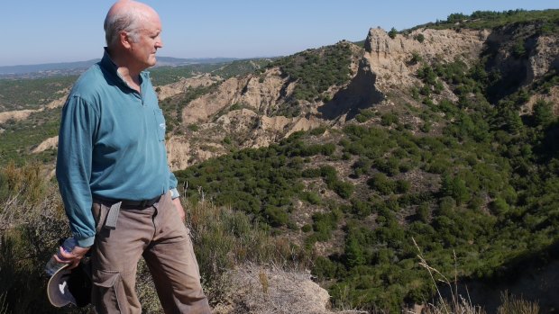 Australian War Memorial historian Richard Reid in the hills above Anzac Cove with the "Sphinx" in the background.