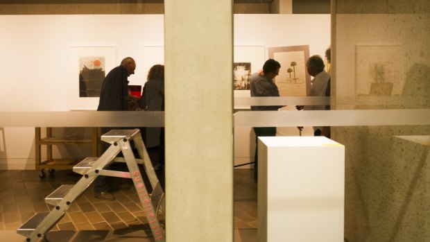 National Gallery of Australia staff work to rehang the collection.