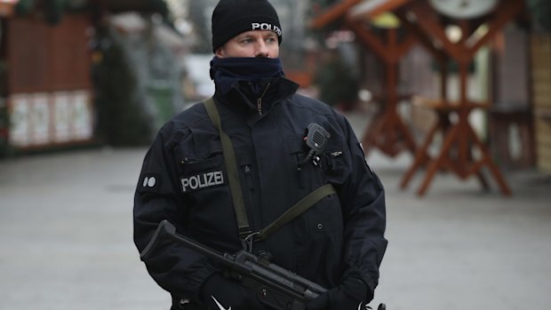 A heavily-armed policeman stands at the site of the attack.