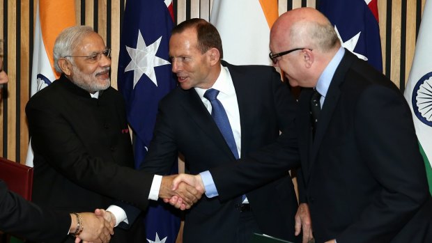 Indian Prime Minister Narendra Modi shakes hand with then prime minister Tony Abbott and Attorney-General George Brandis during his 2014 visit to Australia.