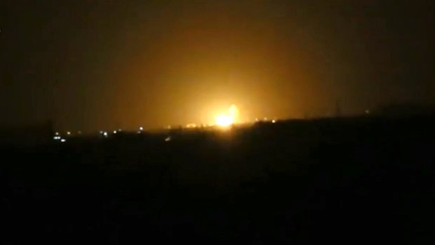 Flames rise after an explosion near an airport west of Damascus, Syria.