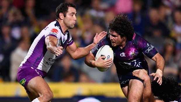 Jake Granville of the Cowboys is tackled by Cameron Smith of the Storm in July. The two teams meet again on Saturday night at AAMI Park in the first qualifying final.