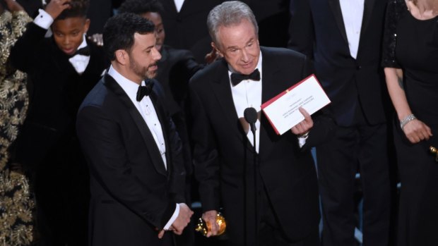 Presenter Warren Beatty shows the envelope with the actual winner for best picture.