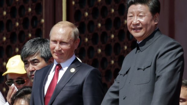Chinese President Xi Jinping, right, and Russian President Vladimir Putin observe a military parade.
