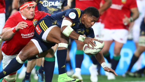 Waisake Naholo of the Highlanders barges through CJ Stander of the Lions to score the opening try.