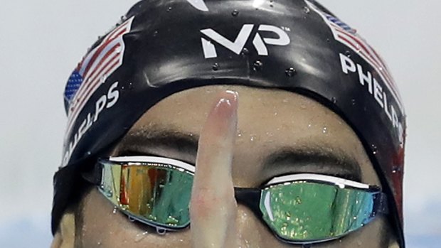Michael Phelps' self-branded "MP" cap split in half just as he prepared to swim the anchor leg of the 4x200 metre freestyle relay.