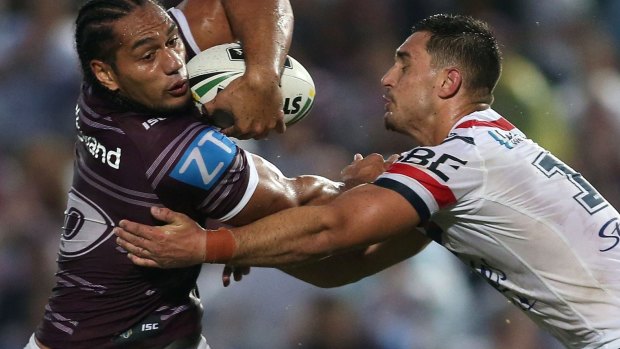 Full-blooded affair: Marty Taupau looks to wriggle out of a tackle.