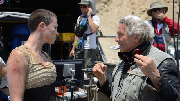 George Miller on the set of Mad Max: Fury Road with Charlize Theron.