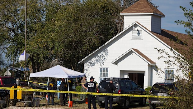 Law enforcement officials works at the scene of a fatal shooting at the First Baptist Church in Sutherland Springs, Texas.