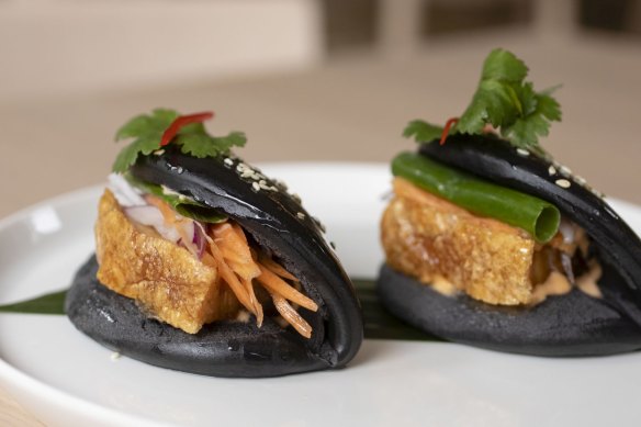 Crackling pork belly in charcoal bao.