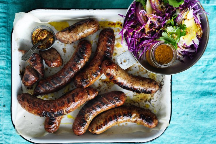 Barbecued sausages with red cabbage and mustard salad.