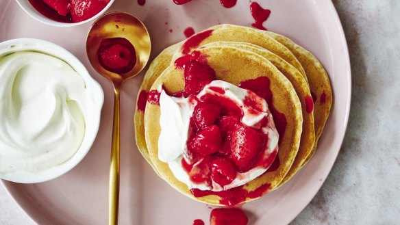 Pancakes with juicy berries and whipped cream.