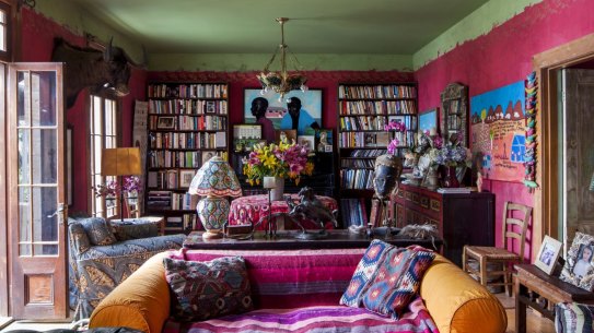 A 100-year-old Turkish green-glass gaslight hangs over the sitting room, enhancing the room’s already vibrant colours. “The striped throw over the orange sofa is a present from my sister.”