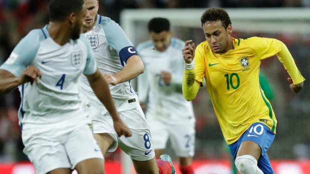 Brazil's Neymar takes the ball forward against England.