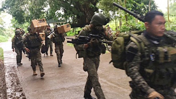Philippine troops arrive at their barracks to reinforce fellow troops following the siege by Muslim militants in the outskirts of Marawi city in southern Philippines.