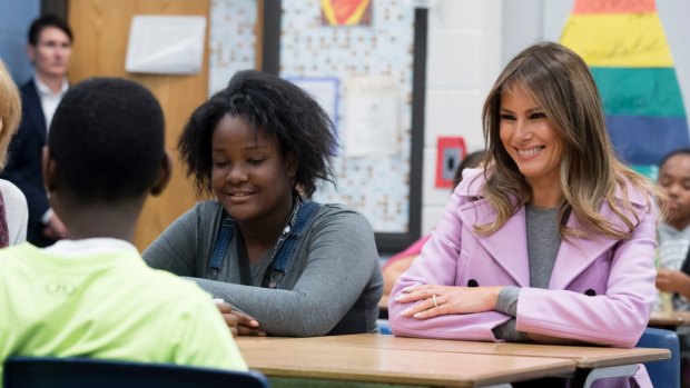 First lady Melania Trump sits with sixth grader Valerie Abulu while visiting a school in West Bloomfield, Michigan.