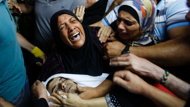 Palestinian relatives mourn over the body of Mohammed Abu Hashhashi, 17, during his funeral in August near Hebron in the Israeli-occupied West Bank.